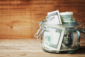 Dollar-bills-in-glass-jar-Saving-money