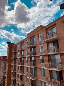 apartment building blue sky fluffy clouds
